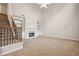 Bright living room featuring a cozy fireplace, carpet and adjacent staircase at 2040 Village Green Dr, Fairburn, GA 30213