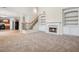 Spacious living room with fireplace and built-in bookshelves, perfect for relaxing and entertaining at 2040 Village Green Dr, Fairburn, GA 30213
