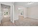 Bright, spacious living area featuring neutral paint, new carpet and multiple doorways offering easy access at 2040 Village Green Dr, Fairburn, GA 30213