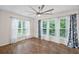 Large bedroom with hardwood floors, a ceiling fan, and lots of natural light from the windows at 4322 Braden Nw Ln, Kennesaw, GA 30144