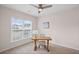 Bright bedroom featuring a large window, ceiling fan, neutral color palette, and carpeted floors at 4322 Braden Nw Ln, Kennesaw, GA 30144