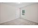 Well-lit bedroom with neutral walls, carpet, a window, and a door at 4322 Braden Nw Ln, Kennesaw, GA 30144