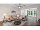 Cozy living room with hardwood floors, ceiling fan, and large windows providing plenty of natural light at 4322 Braden Nw Ln, Kennesaw, GA 30144