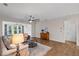 Inviting living room featuring hardwood floors, a ceiling fan, and ample natural light at 4322 Braden Nw Ln, Kennesaw, GA 30144