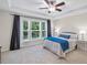 Tranquil main bedroom featuring a tray ceiling, large windows, and stylish decor at 4322 Braden Nw Ln, Kennesaw, GA 30144