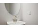 Close-up of bathroom sink with a round mirror and modern faucet at 691 Sunstone Ln, Lawrenceville, GA 30043