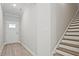 Welcoming foyer features wood stairs, wood-look floors, a white door and neutral wall paint at 691 Sunstone Ln, Lawrenceville, GA 30043