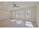 Bright living room with wood-look flooring, recessed lighting, and large windows offering natural light at 691 Sunstone Ln, Lawrenceville, GA 30043