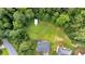 Aerial view of a property with a large backyard, storage shed, and surrounded by lush greenery at 700 Walkingstick Dr, Douglasville, GA 30134