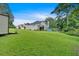 Spacious backyard with lush lawn and view of neighboring homes at 700 Walkingstick Dr, Douglasville, GA 30134
