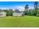 Spacious backyard view showing the home's exterior and surrounding landscape at 700 Walkingstick Dr, Douglasville, GA 30134