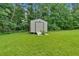 Backyard view features well-maintained lawn and a storage shed at 700 Walkingstick Dr, Douglasville, GA 30134