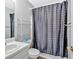 Bathroom featuring a sink, toilet, and shower with gray polka dot curtain at 700 Walkingstick Dr, Douglasville, GA 30134