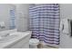 Cozy bathroom featuring a white single sink vanity and a purple-striped shower curtain at 700 Walkingstick Dr, Douglasville, GA 30134