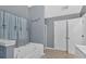 Bright bathroom featuring a soaking tub and dual entry ways at 700 Walkingstick Dr, Douglasville, GA 30134