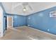 A bedroom featuring blue walls, carpet floors and a modern ceiling fan at 700 Walkingstick Dr, Douglasville, GA 30134