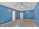 Spacious blue bedroom with carpet flooring, a ceiling fan and bright white trim at 700 Walkingstick Dr, Douglasville, GA 30134