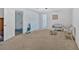 Carpeted living room featuring wicker furniture and dual entries at 700 Walkingstick Dr, Douglasville, GA 30134
