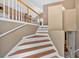 Staircase featuring wood and white, with entry door and railings at 700 Walkingstick Dr, Douglasville, GA 30134