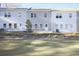 Backyard of newly built townhomes feature a brick foundation and green space at 905 Agate Ln, Lawrenceville, GA 30043
