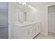 Bright bathroom featuring double sinks with storage beneath the countertop and closet storage at 905 Agate Ln, Lawrenceville, GA 30043