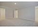 Spacious bedroom with plush carpeting, neutral walls, and doors leading to bathroom and hallway at 905 Agate Ln, Lawrenceville, GA 30043