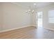 Dining room with an open door to the backyard and modern light fixture at 905 Agate Ln, Lawrenceville, GA 30043