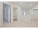 Upstairs hallway with carpeted floors and multiple closets, including one with laundry hookups at 905 Agate Ln, Lawrenceville, GA 30043