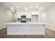 Bright, all-white kitchen features quartz countertops and island at 905 Agate Ln, Lawrenceville, GA 30043