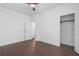 Bedroom features hardwood floors, a ceiling fan, and a closet at 173 Brush Creek Ct, Stockbridge, GA 30281