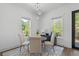 Cozy dining area features modern lighting, a round table, and views of the outdoors at 173 Brush Creek Ct, Stockbridge, GA 30281