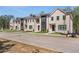Charming townhome exterior with a neatly maintained lawn and accessible street parking at 173 Brush Creek Ct, Stockbridge, GA 30281