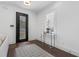 Bright foyer with a stylish front door, shuttered windows, and elegant console table displaying orchids at 173 Brush Creek Ct, Stockbridge, GA 30281