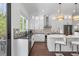 Well-lit kitchen with white cabinets, quartz countertops, stainless steel appliances, and dark hardwood flooring at 173 Brush Creek Ct, Stockbridge, GA 30281