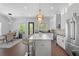 Bright, open kitchen with white cabinetry, stainless steel appliances, large island, and stylish pendant lighting at 173 Brush Creek Ct, Stockbridge, GA 30281