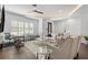 Bright living room with stylish furniture, natural light from shuttered windows, and an adjacent office area at 173 Brush Creek Ct, Stockbridge, GA 30281