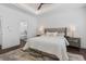 Bright main bedroom features hardwood floors, a luxury king bed, side tables, and ensuite bath at 173 Brush Creek Ct, Stockbridge, GA 30281