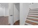 Staircase with wood treads and door leading to an open space in the basement at 173 Brush Creek Ct, Stockbridge, GA 30281