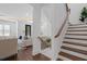 Beautiful staircase with wooden handrail and iron balusters leads to the upper level of the home at 173 Brush Creek Ct, Stockbridge, GA 30281