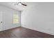 Bedroom with a dark floor, a large window with blinds, and a ceiling fan at 177 Brush Creek Ct, Stockbridge, GA 30218