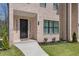 Welcoming townhome entrance with a black front door, manicured landscaping, and a tidy appearance at 177 Brush Creek Ct, Stockbridge, GA 30218