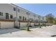 Rear view of new townhomes featuring private balconies, garages, and contemporary design at 177 Brush Creek Ct, Stockbridge, GA 30218