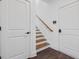 Elegant staircase with wood treads, white risers, and a matching handrail, complemented by a neutral color palette at 177 Brush Creek Ct, Stockbridge, GA 30218