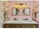 Stylish bathroom with double vanity, ornate light fixture, and decorative mirrors at 244 13Th Ne St # 302, Atlanta, GA 30309
