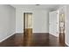 Bedroom featuring hardwood floors, a large window, and an open doorway to a bathroom at 244 13Th Ne St # 302, Atlanta, GA 30309