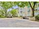 Exterior view of building with mature trees and nicely landscaped entrance at 244 13Th Ne St # 302, Atlanta, GA 30309