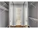 Walk-in closet with mirrored doors, ample shelving, and an adjacent bathroom at 244 13Th Ne St # 302, Atlanta, GA 30309