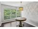 Dining area with wood floors, modern light fixture, and large windows at 244 13Th Ne St # 302, Atlanta, GA 30309