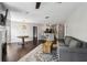 Open-concept living room featuring hardwood floors, a fireplace, and kitchen access at 244 13Th Ne St # 302, Atlanta, GA 30309