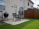 Backyard with a patio area, grill, outdoor seating, grass and a wood fence at 5715 Radford Loop # 15, Fairburn, GA 30213